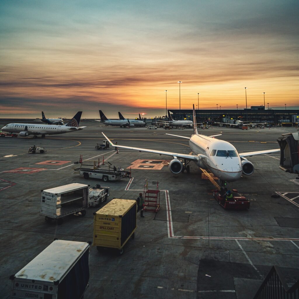 Airplanes at an airport terminal at sunset