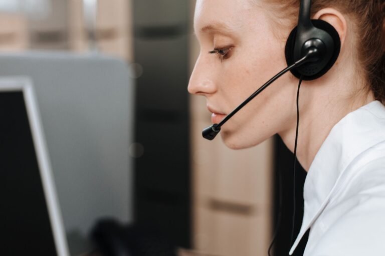 Support agent wearing a headset at her desk
