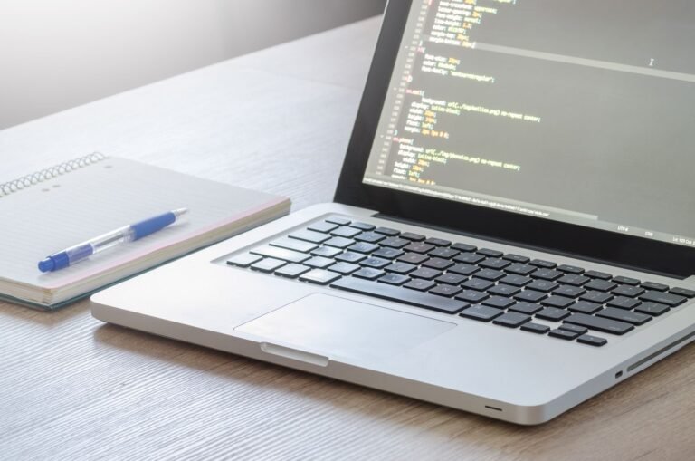 Laptop with code editor on a desk
