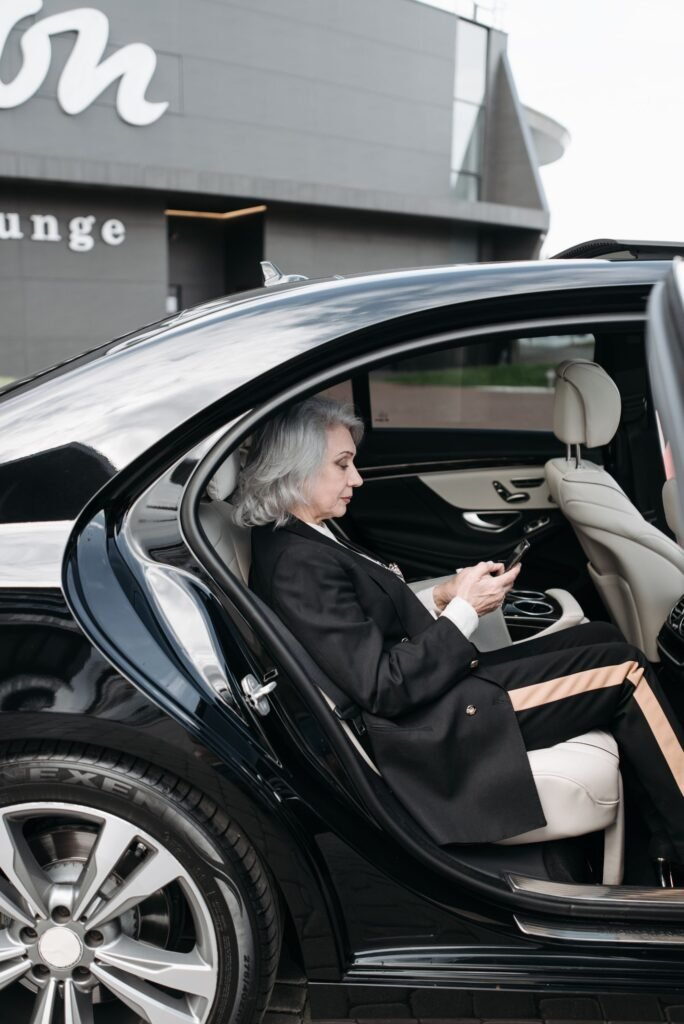 Business traveller using a tablet in the back of a car