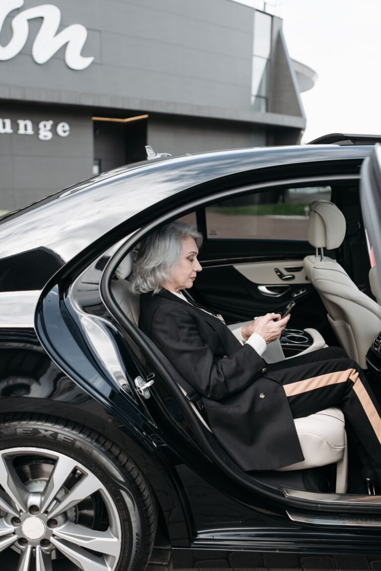 Business traveller using a tablet in the back of a car