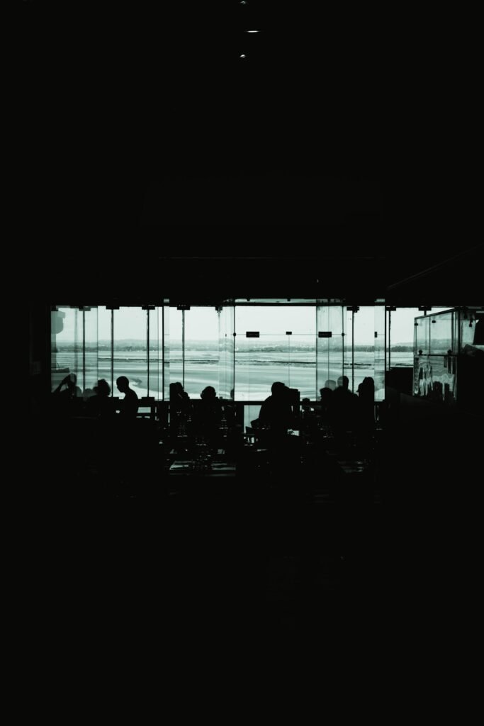Travellers silhouetted in an airport lounge