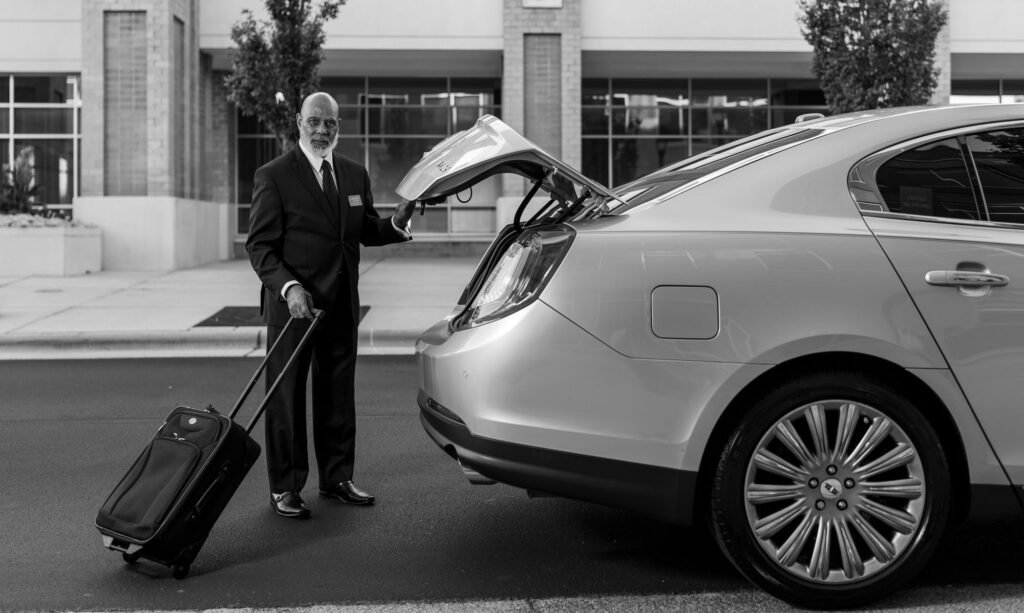Chauffeur loading luggage into a sedan