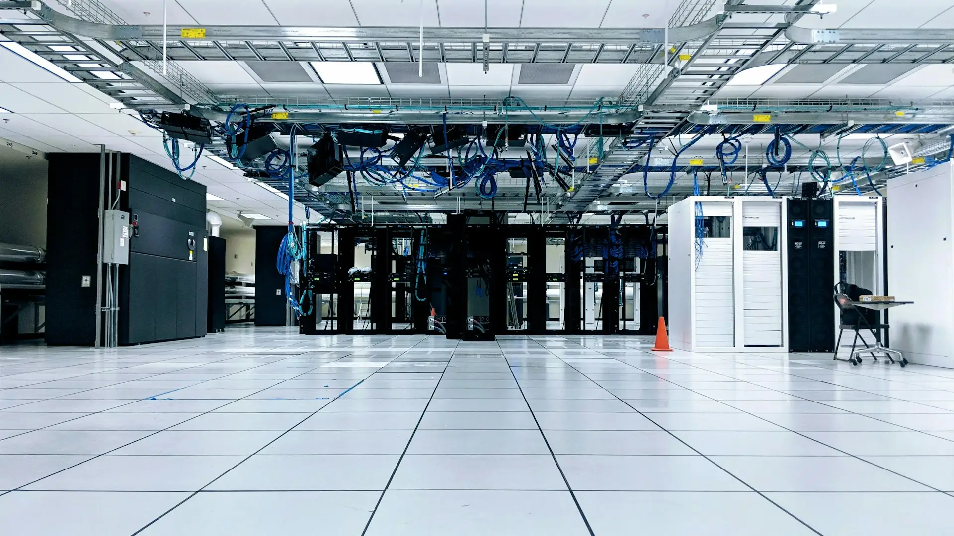Rows of server cabinets in a bright data centre