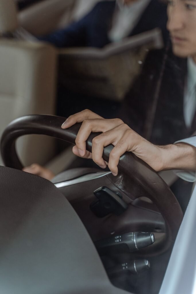 Chauffeur hand on a steering wheel